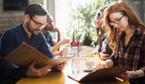 Happy colleagues from work socializing in restaurant