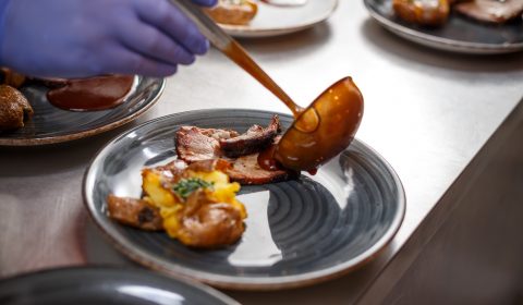 Chef pouring sauce