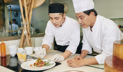 Chefs serving dish at the restaurant